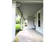 A long gray front porch with white columns providing ample room for chairs, tables and decorations at 4335 River Rd, Columbus, IN 47203