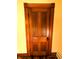 Four panel wooden door in original condition surrounded by decorative wood trim at 4335 River Rd, Columbus, IN 47203