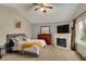Comfortable main bedroom with a fireplace, vaulted ceiling, and large window at 4511 Hunt Master Ct, Indianapolis, IN 46268