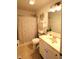 A well-lit bathroom featuring a shower with a decorative curtain, a neutral color scheme, and ample counter space at 5266 Hickory Lake Dr, Indianapolis, IN 46235