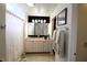 Bright bathroom featuring a vanity with neutral countertops, large mirror, and shower with white curtain at 5266 Hickory Lake Dr, Indianapolis, IN 46235