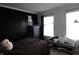 A modern bedroom featuring a dark accent wall, wooden bed frame, and neutral tones for a relaxing ambiance at 5266 Hickory Lake Dr, Indianapolis, IN 46235