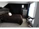 A modern bedroom featuring a dark accent wall, wooden bed frame, and neutral tones for a relaxing ambiance at 5266 Hickory Lake Dr, Indianapolis, IN 46235