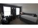Bright bedroom with large windows, a comfortable daybed, desk, and modern decor for a cozy and stylish space at 5266 Hickory Lake Dr, Indianapolis, IN 46235