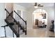 Inviting foyer with stairs and tiled flooring leading into a dining area with a stylish chandelier at 5266 Hickory Lake Dr, Indianapolis, IN 46235