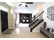 Open-concept foyer with tiled floors, staircase, and a view into a living room with comfortable seating at 5266 Hickory Lake Dr, Indianapolis, IN 46235