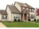 Traditional home with brick and vinyl siding, showcasing manicured lawn, bushes, and tasteful landscaping at 5266 Hickory Lake Dr, Indianapolis, IN 46235