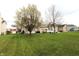Well-manicured front lawn and mature trees create a picturesque setting for this suburban home at 5266 Hickory Lake Dr, Indianapolis, IN 46235