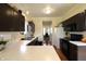 Well-lit kitchen showcasing dark cabinets and sleek, white countertops with stainless steel sink at 5266 Hickory Lake Dr, Indianapolis, IN 46235