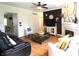 Comfortable living room with hardwood floors, a fireplace, and stylish decor; open to a dining area at 5266 Hickory Lake Dr, Indianapolis, IN 46235
