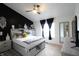 Stylishly decorated main bedroom featuring a modern bed frame, dark accent wall, and ample natural light at 5266 Hickory Lake Dr, Indianapolis, IN 46235