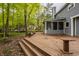 Multi-level back deck with stairs leading to the yard and mature trees at 5467 Winterhazel Dr, Indianapolis, IN 46254