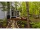 Stone pathway to a back deck with a screened porch and lush greenery at 5467 Winterhazel Dr, Indianapolis, IN 46254