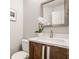 Bathroom featuring white marble countertop, wooden vanity, modern fixtures and decorative orchid at 5467 Winterhazel Dr, Indianapolis, IN 46254