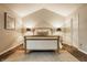 Well lit bedroom with high ceiling, wooden bed frame, carpet and matching side lamps at 5467 Winterhazel Dr, Indianapolis, IN 46254