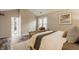 Cozy bedroom with wood floors, neutral walls, and an adjoining bathroom at 5467 Winterhazel Dr, Indianapolis, IN 46254