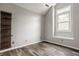 Bright bedroom with hardwood floors, large window and custom shelving at 5467 Winterhazel Dr, Indianapolis, IN 46254