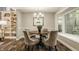 Cozy dining room featuring a round table, comfortable seating, and a bright window at 5467 Winterhazel Dr, Indianapolis, IN 46254