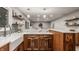 Kitchen with marble countertops, stainless steel appliances and wood cabinets with open layout at 5467 Winterhazel Dr, Indianapolis, IN 46254