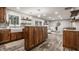 Open kitchen featuring wood cabinets, a large island, stainless steel appliances, and an open layout at 5467 Winterhazel Dr, Indianapolis, IN 46254