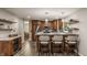 Open kitchen featuring stainless steel appliances, marble countertop, bar seating and wood cabinets at 5467 Winterhazel Dr, Indianapolis, IN 46254