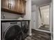 Laundry room with modern washer and dryer, upper cabinets, and folding counter at 5467 Winterhazel Dr, Indianapolis, IN 46254