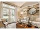 Bright living room with built-in shelving, a neutral-toned sofa, decorative accents, with a large window at 5467 Winterhazel Dr, Indianapolis, IN 46254
