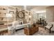 Bright living room with built-in shelving, a neutral-toned sofa, decorative accents, with a peek into dining area at 5467 Winterhazel Dr, Indianapolis, IN 46254