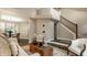 Bright living room with a neutral-toned sofa, decorative accents, and a staircase with a dining space view at 5467 Winterhazel Dr, Indianapolis, IN 46254