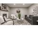 Comfortable living room with a white brick fireplace, plush seating, and a geometric rug at 5467 Winterhazel Dr, Indianapolis, IN 46254