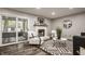 Bright living room with a white brick fireplace and sliding glass doors at 5467 Winterhazel Dr, Indianapolis, IN 46254