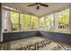 Cozy screened porch with a ceiling fan and scenic wooded views at 5467 Winterhazel Dr, Indianapolis, IN 46254