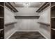 Walk-in closet with custom shelving, overhead lighting and wood floors at 5467 Winterhazel Dr, Indianapolis, IN 46254
