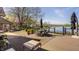 Lovely water view from the back deck with patio furniture and a fire pit for entertaining guests at 5872 Lake Kessler Ct, Indianapolis, IN 46226