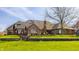 Backyard showing the brick exterior, lush landscaping, and inviting deck, perfect for relaxing and entertaining at 5872 Lake Kessler Ct, Indianapolis, IN 46226