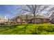 Well maintained backyard with brick house, lush landscaping, and a spacious deck, perfect for outdoor entertaining at 5872 Lake Kessler Ct, Indianapolis, IN 46226