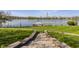 Lush green lawn leading to a private dock with serene water views and mature trees at 5872 Lake Kessler Ct, Indianapolis, IN 46226