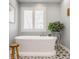Tranquil bathroom featuring a freestanding tub, natural light, and decorative accents at 5872 Lake Kessler Ct, Indianapolis, IN 46226