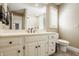 Bathroom featuring a white vanity with elegant fixtures and a toilet at 5872 Lake Kessler Ct, Indianapolis, IN 46226