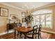 Elegant dining room featuring a chandelier and a large window offering plenty of natural light at 5872 Lake Kessler Ct, Indianapolis, IN 46226