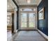 Elegant foyer featuring decorative glass double doors and a blue accent wall at 5872 Lake Kessler Ct, Indianapolis, IN 46226