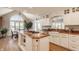 Well-equipped kitchen featuring an island cooktop, granite countertops, and bright adjacent dining area at 5872 Lake Kessler Ct, Indianapolis, IN 46226