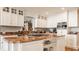 Spacious kitchen boasts custom cabinetry, granite countertops, and a center island with cooktop at 5872 Lake Kessler Ct, Indianapolis, IN 46226