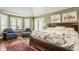 Relaxing main bedroom with plenty of natural light, featuring a seating area and elegant decor at 5872 Lake Kessler Ct, Indianapolis, IN 46226