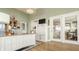 Well-lit home office with desk, shelving, and access to the sunroom at 5872 Lake Kessler Ct, Indianapolis, IN 46226