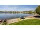 Picturesque waterfront view with a charming small boat resting by the shoreline and residential street beyond at 5872 Lake Kessler Ct, Indianapolis, IN 46226