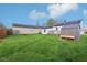 Expansive backyard features lush green grass and a functional shed and wooden deck at 600 Alexandria Pike, Anderson, IN 46012