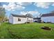 Spacious backyard features a well-maintained lawn, shed, fire pit, and a charming deck at 600 Alexandria Pike, Anderson, IN 46012