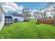 Large backyard featuring a shed, fire pit, and grassy lawn at 600 Alexandria Pike, Anderson, IN 46012