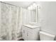 Bathroom with white vanity, patterned shower curtain and modern fixtures at 600 Alexandria Pike, Anderson, IN 46012